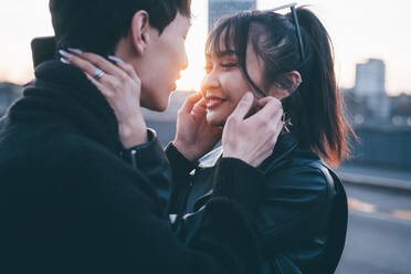 Affectionate young couple on street, Milan, Italy - CUF54104