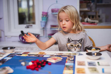 Girl playing board game - JOHF04935