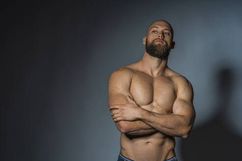 Portrait of a barechested athlete in studio - DLTSF00312