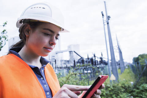 Female worker using tablet on industrial site stock photo