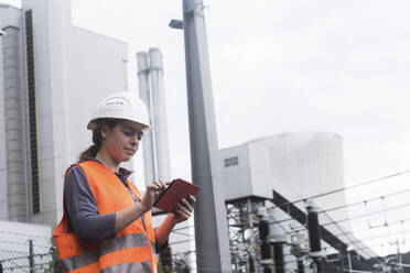 Arbeiterin benutzt Tablet im Kraftwerk - SGF02497