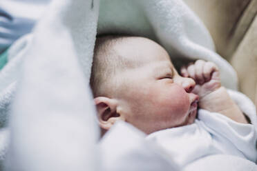 Portrait of baby boy lying on a bed - LJF01130