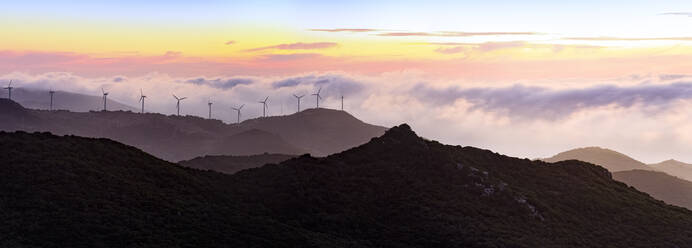 Gibraltar, Wind turbines in landscape at sunset - FCF01853