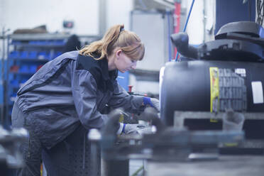 Female car mechanic working in repair garage - SGF02527