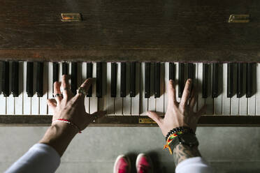 Man's hands playing the piano - EYAF00771