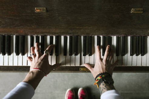 Man's hands playing the piano - EYAF00771