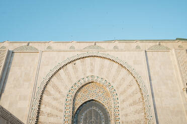 Low angle view of Mosque Hassan II against clear sky - CAVF70773