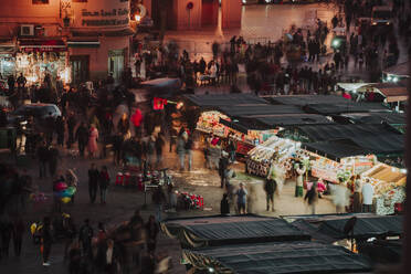 High angle view of people at Marrakesh market during night - CAVF70778