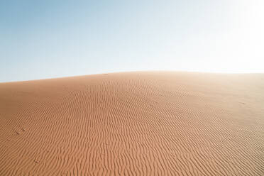 Scenic view of desert against clear sky during sunny day - CAVF70781