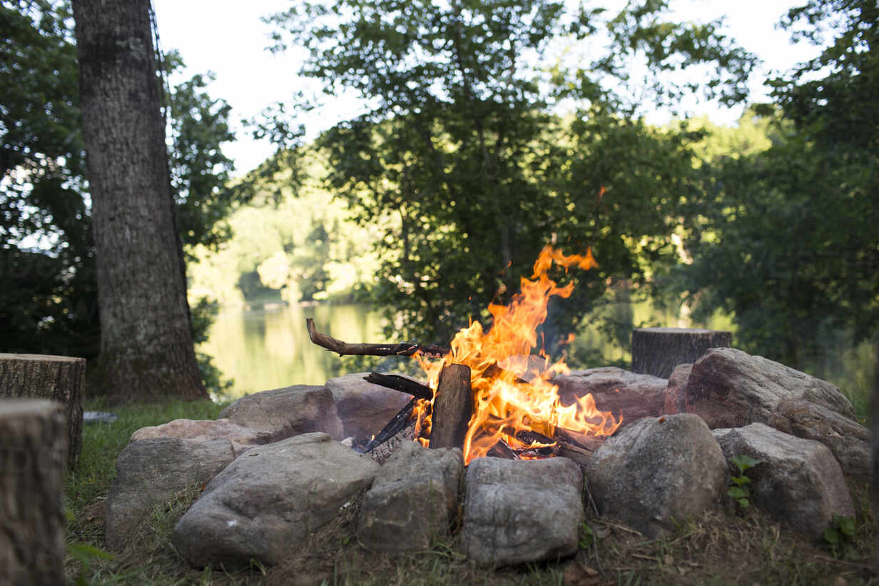 High angle close up of kettle over camp fire in a forest. stock photo