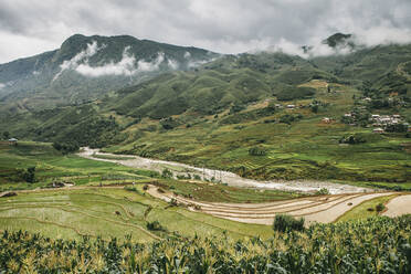 High angle view of rice terrace against mountains and cloudy sky - CAVF70885