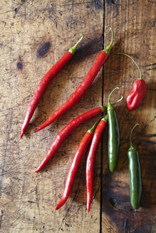 Overhead view of chili peppers on wooden table - CAVF70914