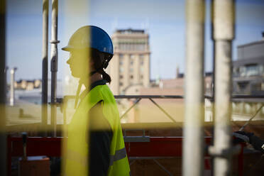 Side view of female architect at construction site - MASF15974