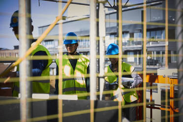 Male and female engineers in workwear at construction site - MASF15975