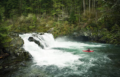 High angle view of kayaker on river in forest - CAVF71109