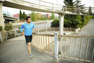 Male athlete jogging on bridge - CAVF71134