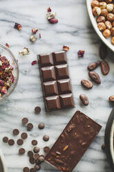 High angle view of chocolates with coco beans on kitchen counter - CAVF71308