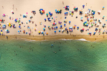 Aerial view of people at public beach Spiaggia di Cala Sinzias, Cagliari, Italy. - AAEF06220