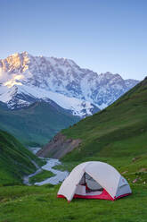 Tent at the head of Enguri gorge in front of Shkhara peak. Ushguli, Samegrelo-Zemo Svaneti region, Georgia - CAVF71551