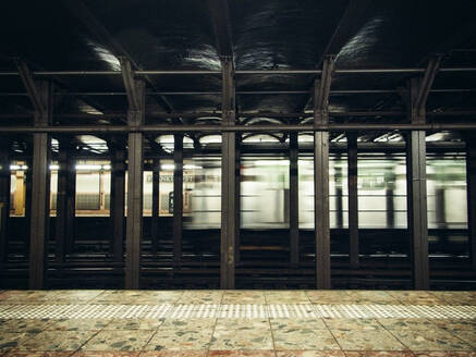 Innenansicht einer U-Bahn, die durch eine Station in NYC fährt - CAVF71693