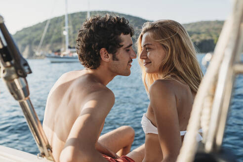 Affectionate couple on sailboat, Italy - CUF54204