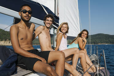 Friends relaxing on sailboat, Italy - CUF54220