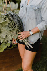 Woman gardener with fresh produce from garden - CUF54257