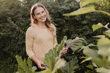 Woman gardener with fresh produce from garden - CUF54260