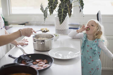 Girl eating in kitchen - JOHF05125