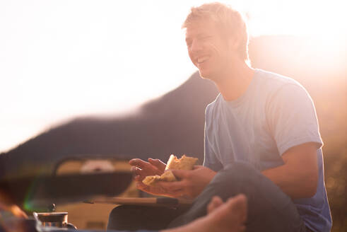 Man having breakfast in wilderness at sunrise - ISF23357