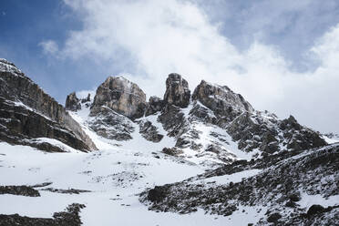 Scenic view of snowcapped mountain against cloudy sky - CAVF72311