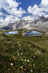 Idyllic view of lakes against mountains and cloudy sky - CAVF72350