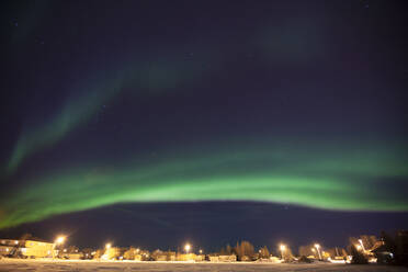 Idyllic view of aurora borealis over houses - CAVF72403