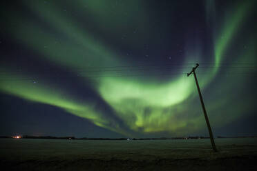 Low angle view of aurora borealis over electricity pylon - CAVF72404