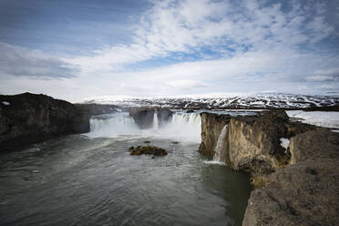 Scenic view waterfall against sky during winter - CAVF72433