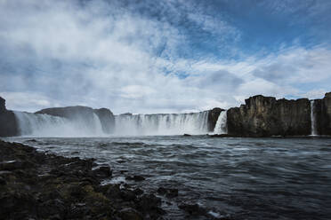 Scenic view of waterfall against sky - CAVF72434