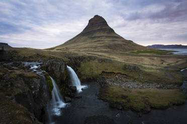 Scenic view of waterfall and mountain against sky - CAVF72440