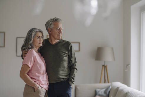 Senior couple standing in living room at home - GUSF03051