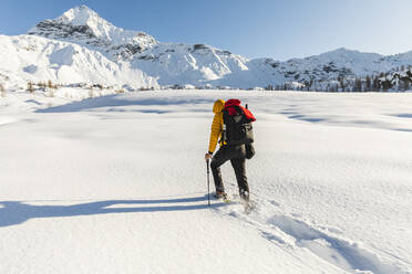 Hiking with snowshoes in the mountains, Valmalenco, Sondrio, Italy - MCVF00131