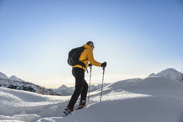 Hiking with snowshoes in the mountains, Valmalenco, Sondrio, Italy - MCVF00135