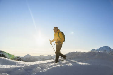 Hiking with snowshoes in the mountains, Valmalenco, Sondrio, Italy - MCVF00140