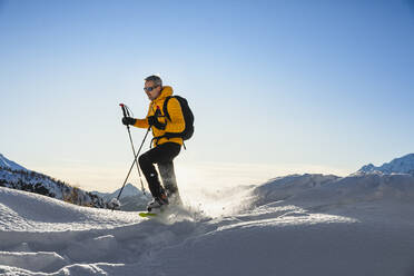 Hiking with snowshoes in the mountains, Valmalenco, Sondrio, Italy - MCVF00142