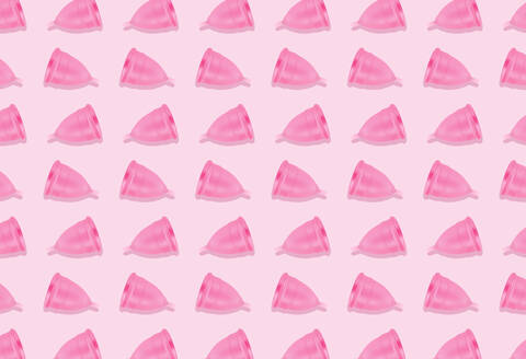 Eco-friendly and reusable pink menstrual cup pattern on pink background stock photo