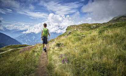 Boy hiking in alpine scenery, Passeier Valley, South Tyrol, Italy - DIKF00333
