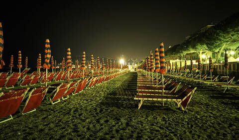 Strand mit Liegestühlen bei Nacht, San Bartolomeo al Mare, Italien, lizenzfreies Stockfoto