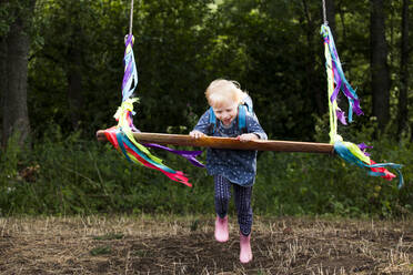 Little girl having fun with a swing - IHF00232