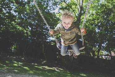 Happy little boy on a swing - IHF00250