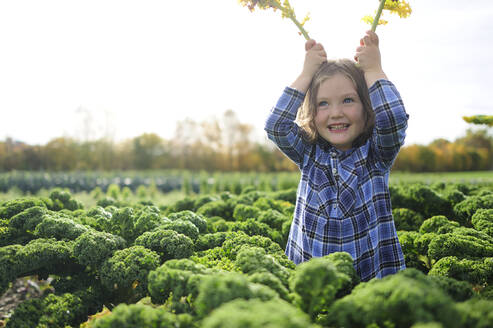 Girl in a kali field, leaves as rabbit ears - ECPF00778