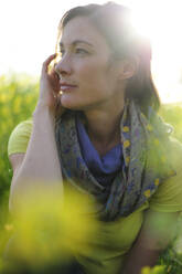 Portrait of woman in the nature, wearing green t-shirt and scarf - ECPF00814