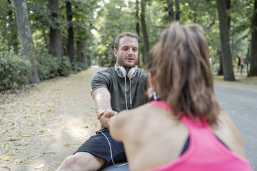 Mann und Frau trainieren auf einem Fitnessparcours - FBAF01100